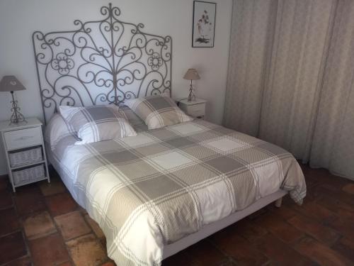 una camera con un grande letto con testiera metallica di Mas Sicard chambre d'hôtes en Camargue a Arles
