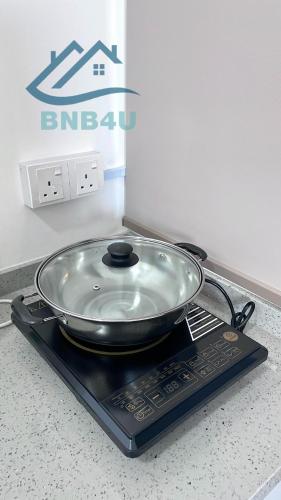 a pan sitting on top of a stove at Urban Suites Georgetown by BNB4U in Jelutong