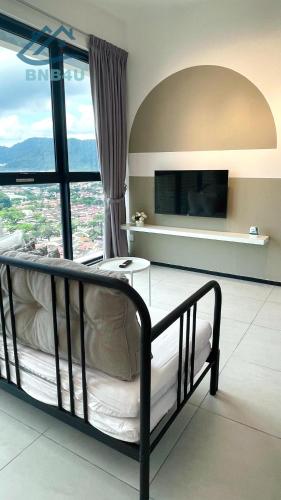 a bedroom with a bed and a large window at Urban Suites Georgetown by BNB4U in Jelutong
