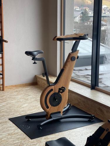 a exercise bike in a room with a window at Hotel Post in Prutz