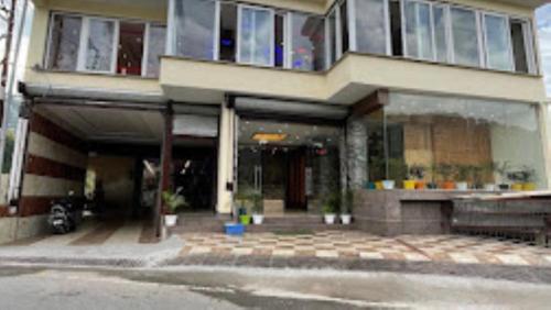 a large building with a front porch at Hotel Nature’s View Loharkar in Dharmsala