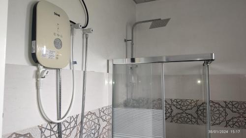 a shower in a bathroom with a glass shower stall at Laxsume Guest House Nilaveli in Nilaveli