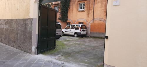 an open door to a parking lot with a white van at Casa per ferie religiosa Figlie di Nazareth in Pisa