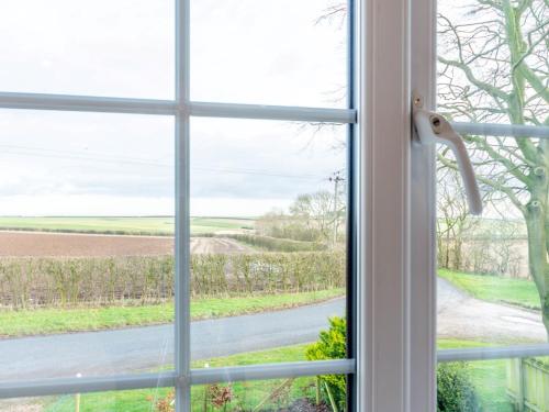 a window with a view of a road at 4 Bed in Langtoft 81235 in Weaverthorpe