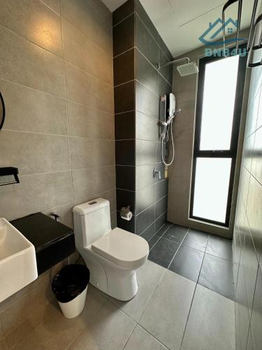 a bathroom with a toilet and a sink and a phone at Urban Suites Georgetown by BNB4U in Jelutong