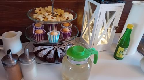 a table with a plate of cupcakes and a drink at Penzión Vilka Podhájčanka in Podhájska