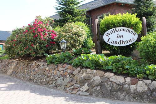 a sign for a garden with flowers and plants at Landhaus Göddertzhof in Erkelenz