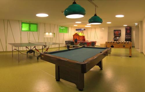 a room with a pool table and two ping pong tables at Landhotel Burg im Spreewald - Resort & Spa in Burg