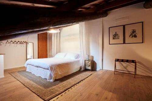 a bedroom with a white bed and a large window at L’Abbaino in Vicenza