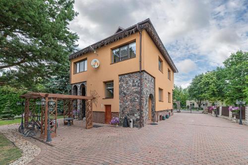 a building on a brick road in front at Spacious Studio apartment by Polo apartments in Kaunas