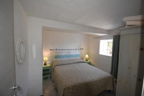 a bedroom with a bed and a window in it at appartamento sulla spiaggia 1 in Olbia