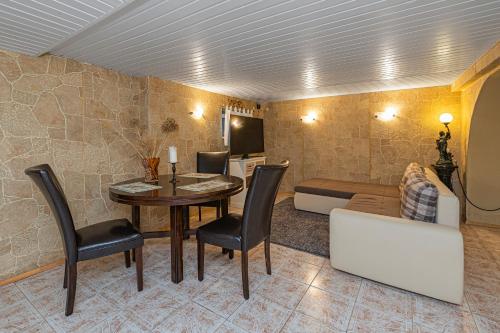 a living room with a table and chairs and a couch at Spacious Studio apartment by Polo apartments in Kaunas