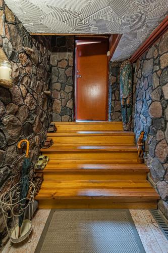 a staircase in a stone building with a wooden door at Spacious Studio apartment by Polo apartments in Kaunas
