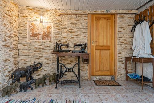 a room with a wooden table and animals on the wall at Spacious Studio apartment by Polo apartments in Kaunas