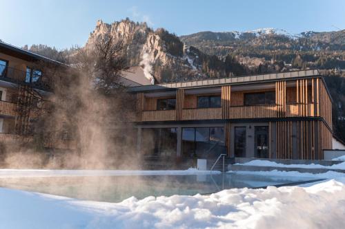 a building with snow in front of it at Hotel Post in Prutz
