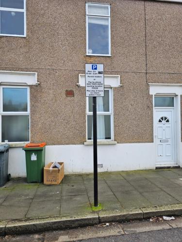 a parking sign on a sidewalk in front of a building at Umbrella Properties London Excel in London