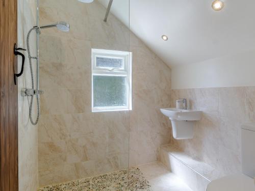 a bathroom with a shower and a toilet and a sink at 3 Bed in Syderstone 78973 in Syderstone