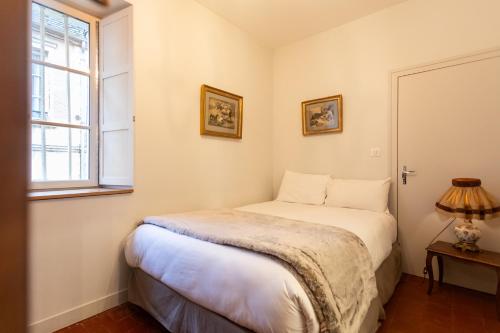 a bedroom with a bed and a window at L' Hotel de Panette, entrée Renaissance Cathédrale in Bourges
