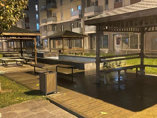 a park with benches and a pavilion in a city at Site in Istanbul