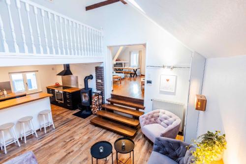 a living room with a staircase and a dining room at Le Cottage in Furdenheim