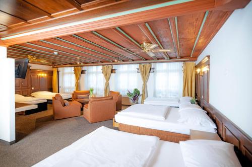 a hotel room with two beds and a couch at Hotel Baslertor in Lucerne