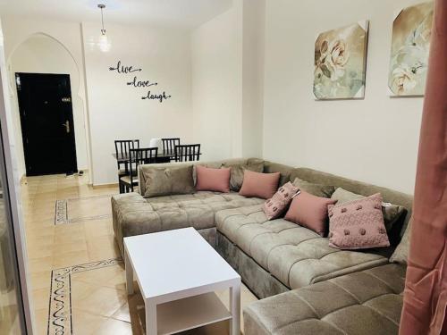 a living room with a couch and a table at SAIDIA AP4 cosy avec piscine in Saidia 