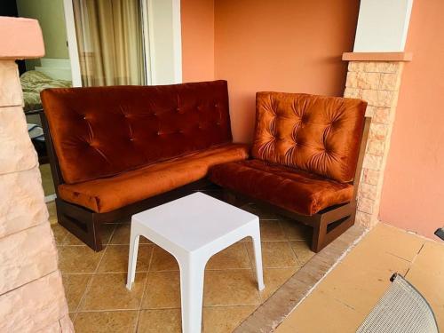 a living room with a couch and a table at SAIDIA AP4 cosy avec piscine in Saidia 