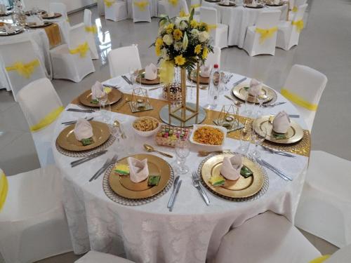 a white table with hats and plates of food on it at Hole In One in Roodepoort
