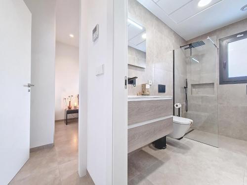 uma casa de banho com um WC, um lavatório e um chuveiro em Villas Alejandra - 8309 em Santiago de la Ribera