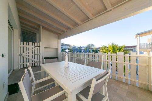 a white table and chairs on a balcony at Cala Blu in Lido di Jesolo