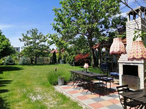 a backyard with a picnic table and a fireplace at Penzión Vilka Podhájčanka in Podhájska