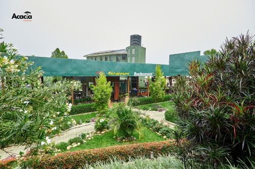 um edifício com um jardim em frente em Acacia Country Inn em Mbarara