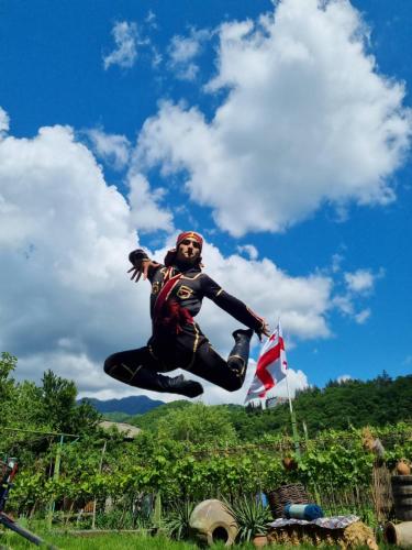 a man is jumping in the air with a flag at Lunisi Kvareli in Kvareli
