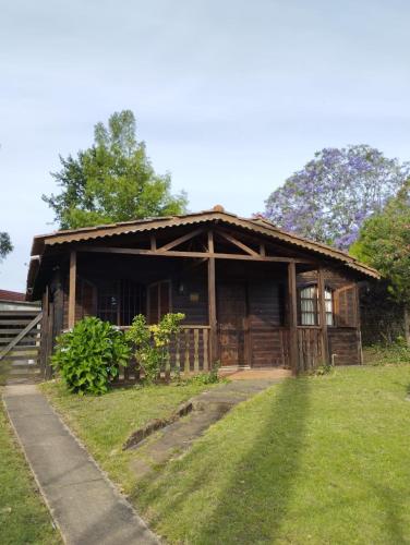 una pequeña casa de madera con un patio de césped en Buena energía y confort, en La Floresta
