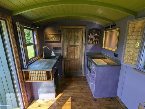 a kitchen with purple counters and a sink at Blue Sky Huts in Chediston