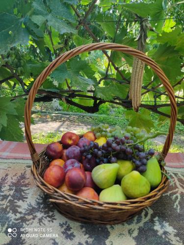 a basket of fruit sitting on a table at Lunisi Kvareli in Kvareli