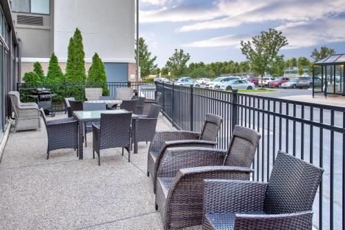 a row of chairs and tables on a patio at Holiday Inn Express Hotel & Suites - Belleville Area by IHG in Belleville