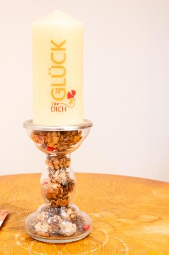 a candle on top of a glass stand on a table at Ferienwohnungen - barrierefrei - im sanierten Gutshof in Lalendorf