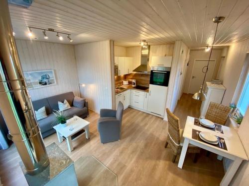オルペニッツにあるFerienhaus Skipper Hus by Seeblick Ferien ORO, Kamin,Saunaの小さなリビングルーム(ソファ、テーブル付)