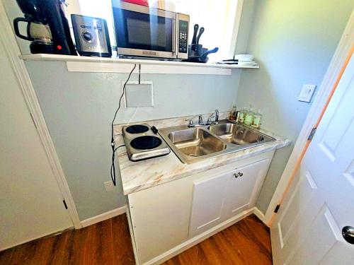 a small kitchen with a sink and a microwave at 1BR Nest in Grass Valley, CA in Grass Valley