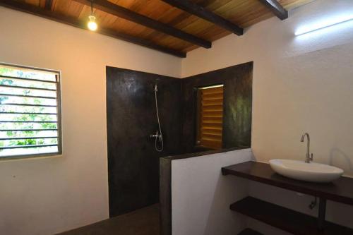 a bathroom with a sink and a shower at Eco Lodge Cristal Nosy Komba in Nosy Komba