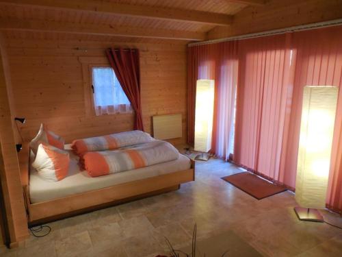 1 dormitorio con 1 cama en una habitación de madera en Ferienhaus Blockhaus by Seeblick Ferien Edersee en Waldeck