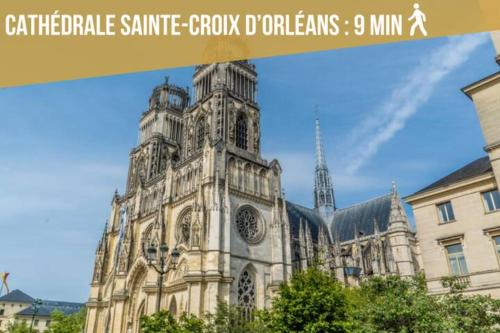 a large building with a clock tower in front of it at La Bretonnerie *T2* in Orléans