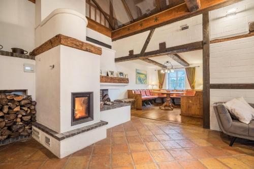an open living room with a fireplace and a table at Ferienwohnung Juttashof in Camin