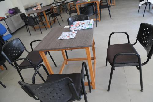 a wooden table and chairs in a room at Suryaansh in Pālghar