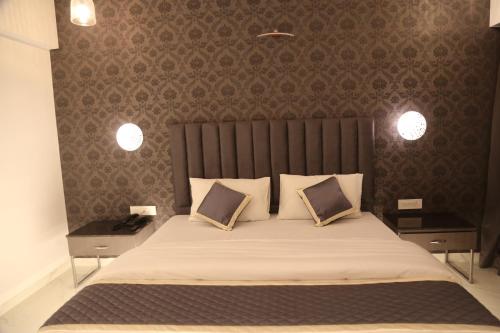 a bedroom with a large bed with two night stands at Suryaansh in Pālghar