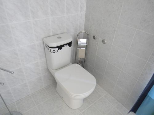 a bathroom with a toilet with a sticker on it at Smart Rooms in Trieste