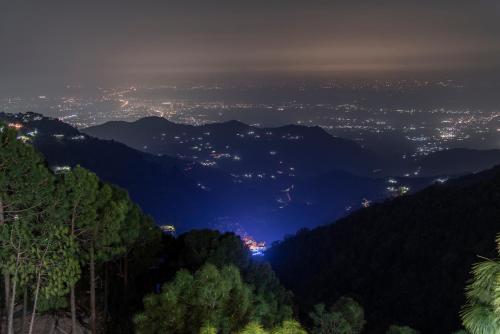 a view of a city at night at Vansathli I Near Mall Road Kasauli I Open Garden & Rooftop I by Humble stay villa in Kasauli