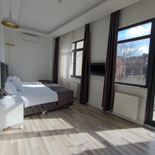 a bedroom with a bed and a large window at Efzen hotel in Istanbul