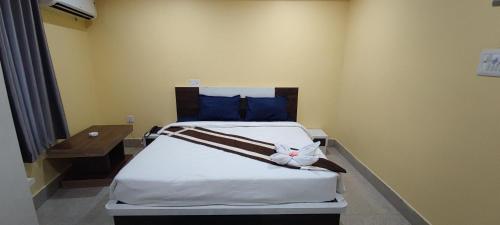 a bedroom with a bed with a stuffed animal on it at Panda Continental in Bhubaneshwar